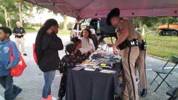 photo of community members interacting with the police at National Night Out