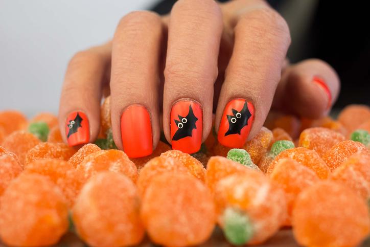 Halloween nails with bat googly eyes.