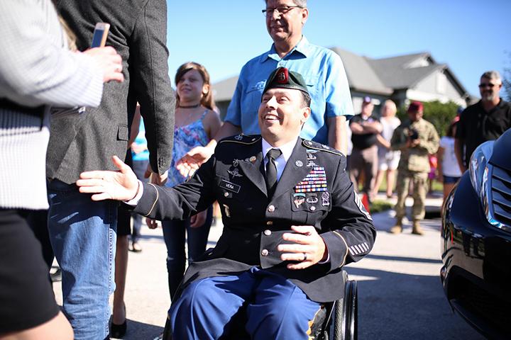 One of our veteran heroes Master Sergeant George Vera in front of a crowd smiling.